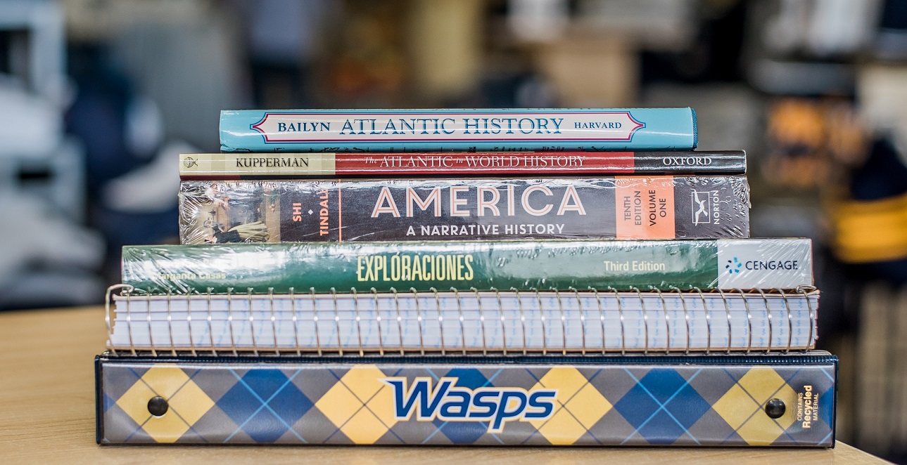 a stack of books and paper supplies